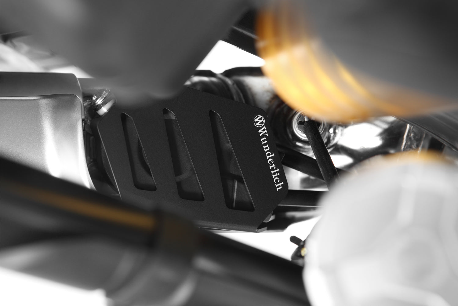Damage from stones and accidental boot damage can no longer occur with this Wunderlich Exhaust flap cover.