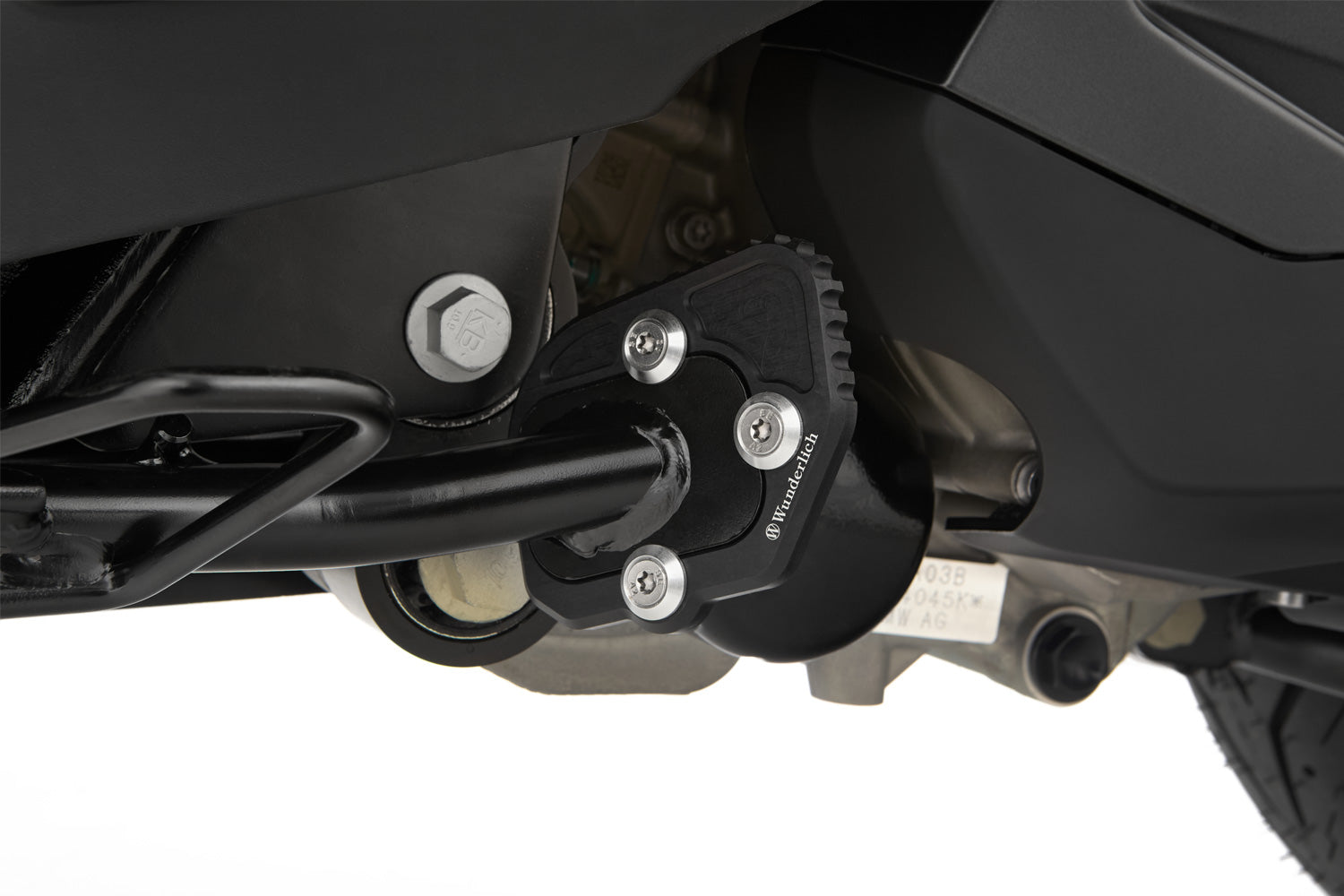 A precisely milled enlarger that can be quickly screwed onto the side stand effectively eliminates this design flaw