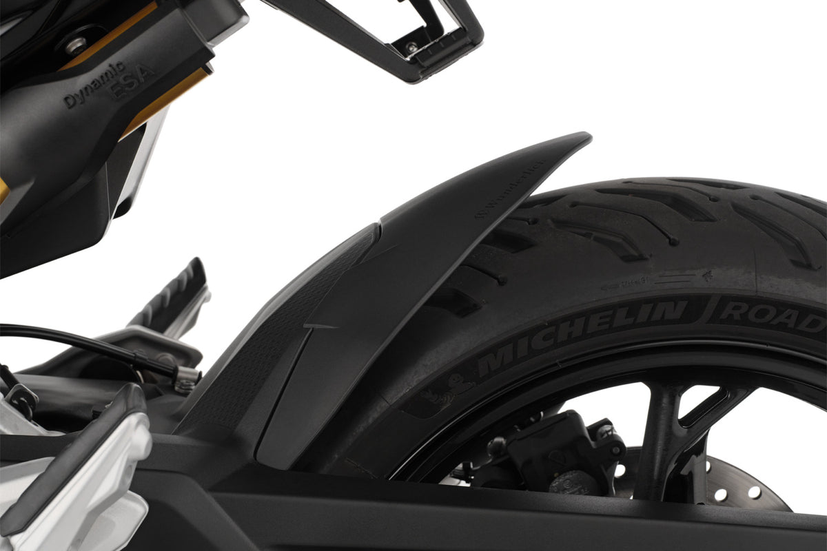 The area around the swing arm pivot, the swing arm, the collector, the gears and the shock absorber are in front of the rear wheel and thus