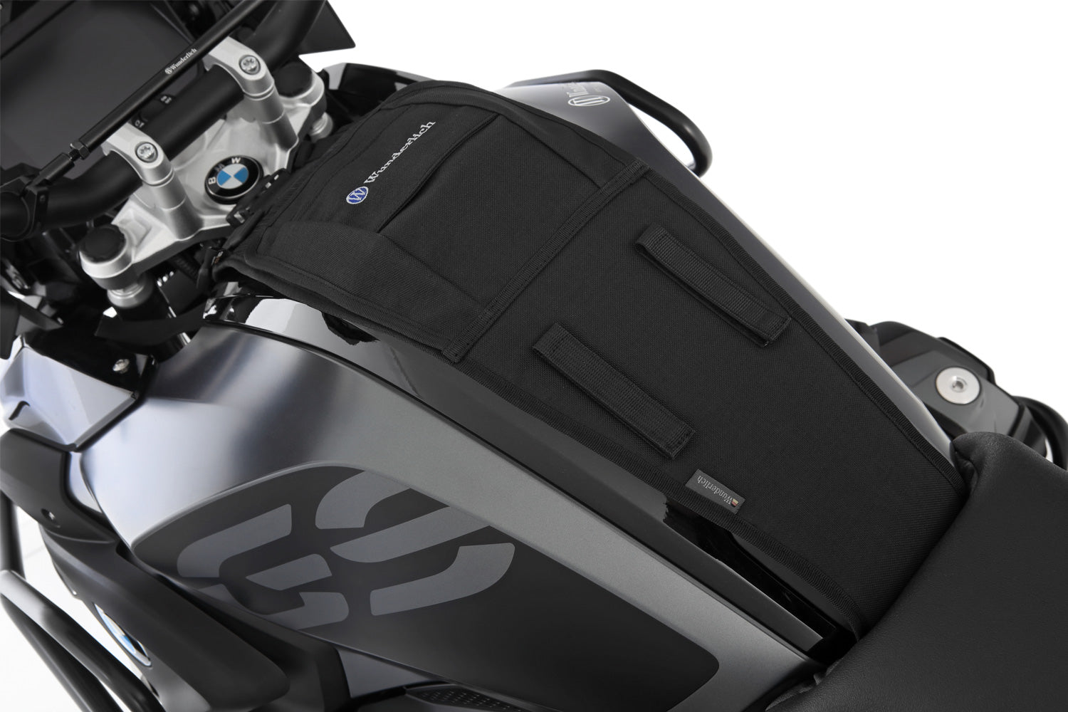 The mounting system is attached to the vehicle with minimal hand pressure and the tank bag can be quickly fastened to it. 