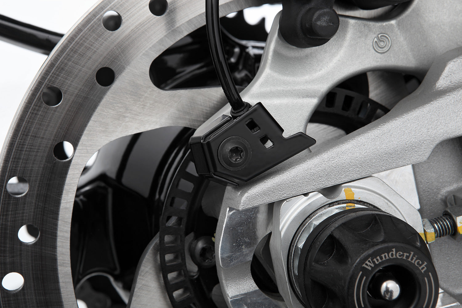 Reliable, effective protection of the safety-relevant ABS sensor of the rear wheel